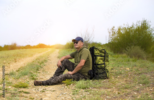 A traveler is walking along the road with a backpack