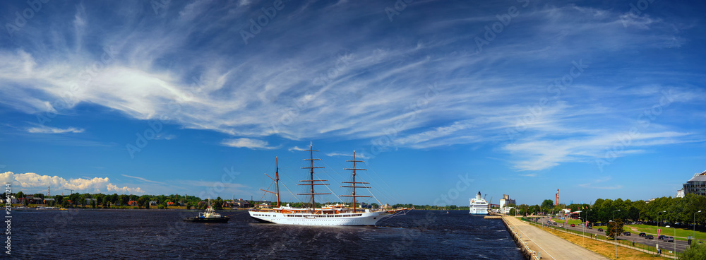 Panorama of the port of Riga with a sailboat