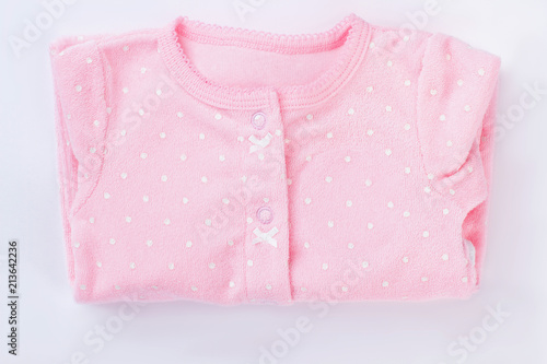 Pink folded baby pajamas isolated on white.