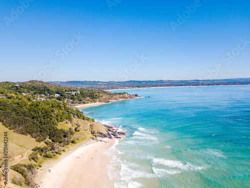 The Pass and Wategoes Beach at Byron Bay from an aerial view with blue water © Darren