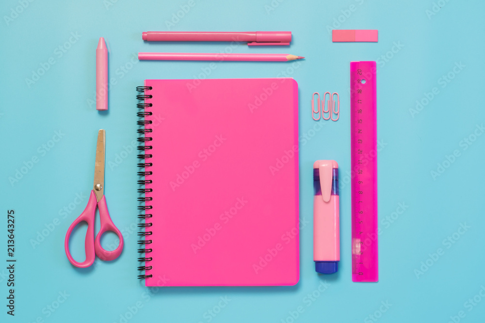 Pink girlish school supplies, notebooks and pens on punchy blue. Top view, flat lay. Copy space. Pink girlish school supplies, notebooks and pens on punchy blue. Top view, flat lay. Copy space.