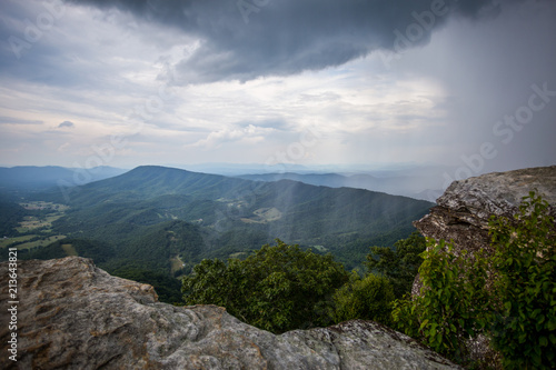 Awesome Scenic view from McAfee Knob of Clouds and Sheets of Rain fall in Valley with mountains in the distance photo