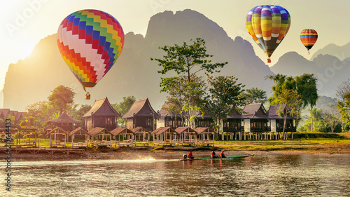 Hot air balloon over Nam Song river at sunset in Vang vieng, Laos.