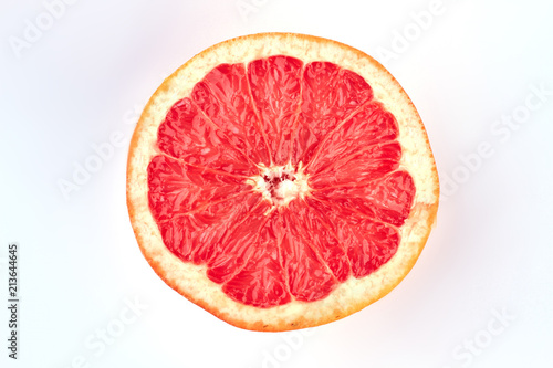 Pink ripe grapefruit  top view. Ripe half of pink grapefruit citrus on light background.