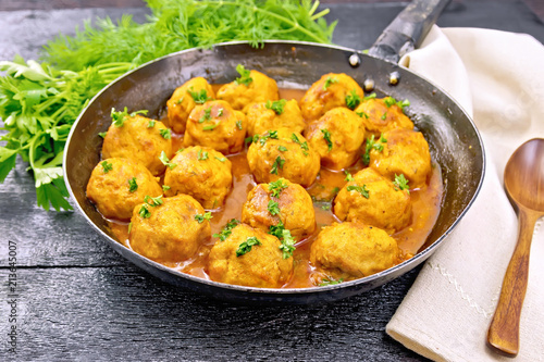 Meatballs in pan with sauce on board