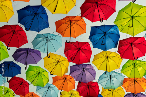 Multicolored umbrellas against the sky  street decorated