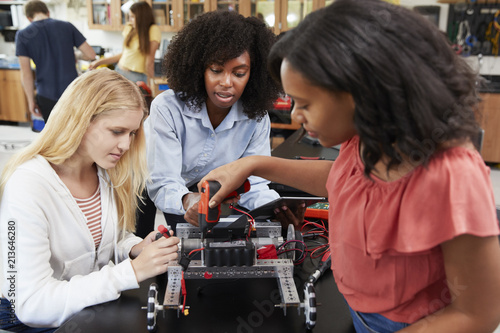 Teacher With Female Pupils Building Robotic Vehicle In Science Lesson © Monkey Business