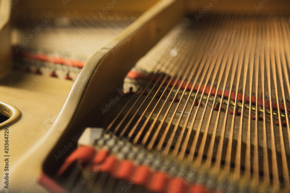 The inside of a classical grand piano instrument with copper cord strings. The inside of a classical grand piano instrument with copper cord strings.