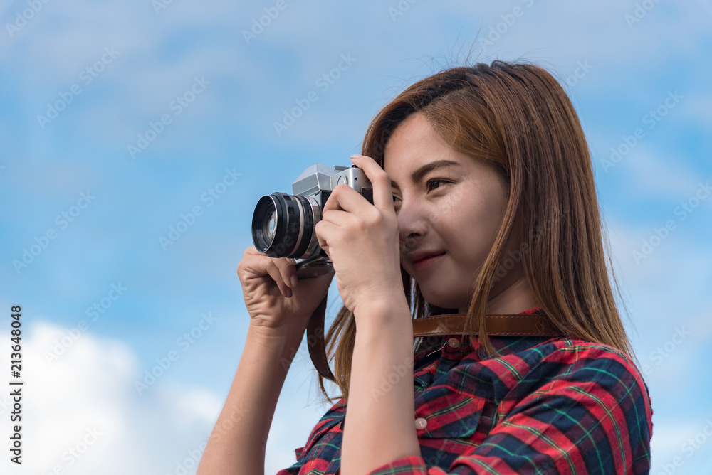 Young hipster Asian woman taken a photo.