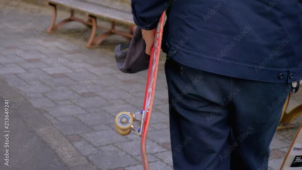 Young Japanese man carrying two skateboards. Young Japanese man carrying two skateboards.