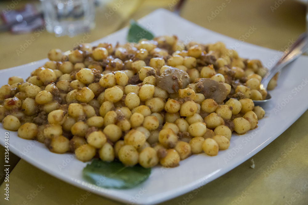 close-up with detail of a typical Italian dish called gnocchi with sausage sauce close-up with detail of a typical Italian dish called gnocchi with sausage sauce