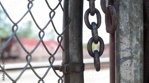 Swinging chain with fence. photo