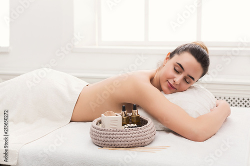 Woman ready to get classical back massage at spa