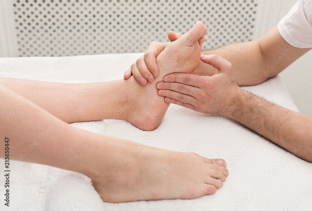 Feet massage closeup, acupressure Feet massage closeup, acupressure