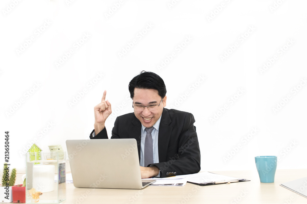 Young businessman working with laptop and office Supplies.He looking smiling.Copy space. Young businessman working with laptop and office Supplies.He looking smiling.Copy space.