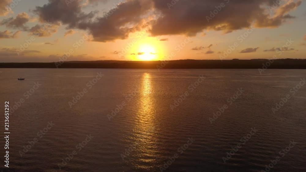 Sunset between 2 catamaran boats on a river at dusk in Paraíba, Brazil Sunset between 2 catamaran boats on a river at dusk in Paraíba, Brazil