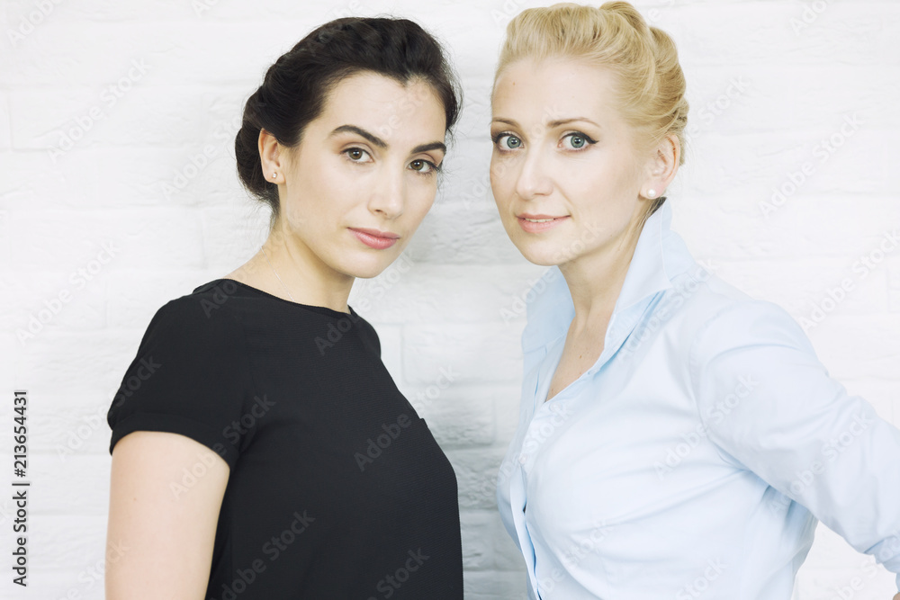 The company of young women friends laugh, make hair and makeup The company of young women friends laugh, make hair and makeup