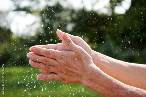 Wet hands and flying water drops.