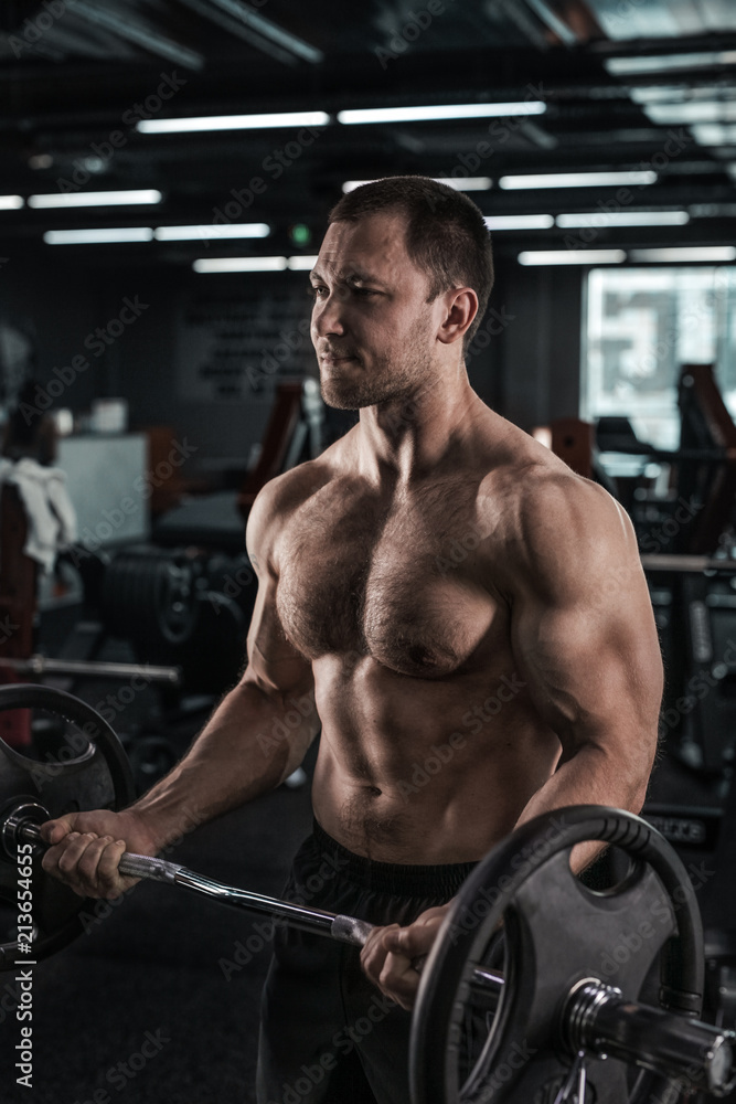 Muscular man working out in gym