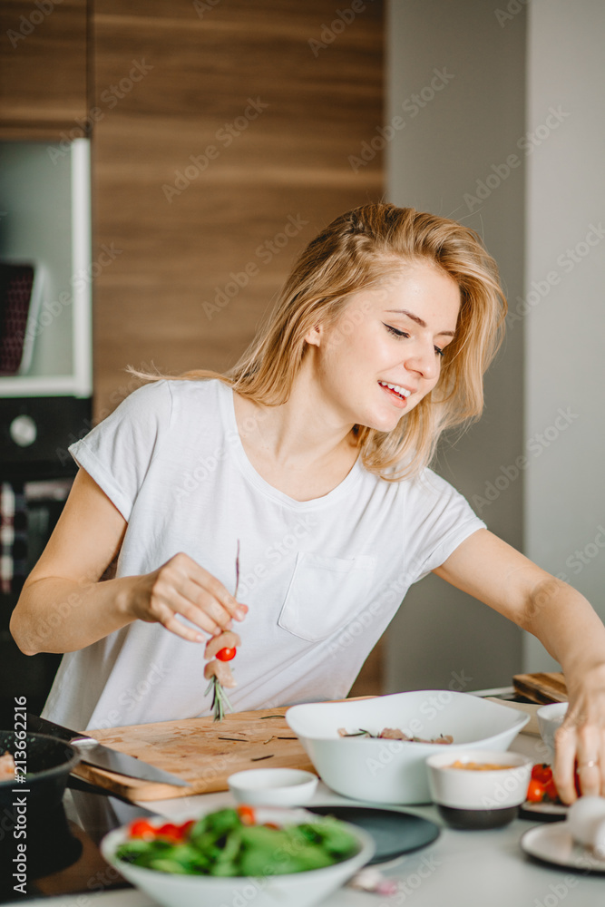 joyful blonde preparing canape for relatives.close up side view portrait joyful blonde preparing canape for relatives.close up side view portrait