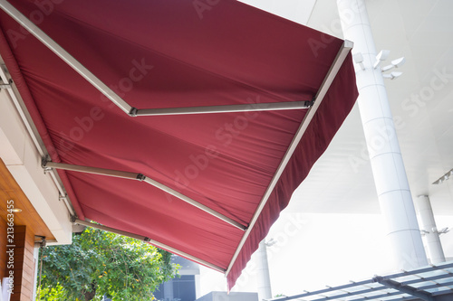 Photos red awning with steel structure at the front door.
