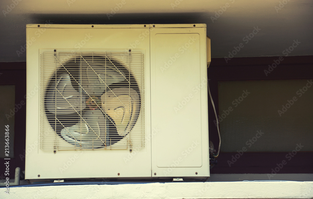 air condition outdoor unit compressor install outside the house.Vintage style filtered photo. air condition outdoor unit compressor install outside the house.Vintage style filtered photo.