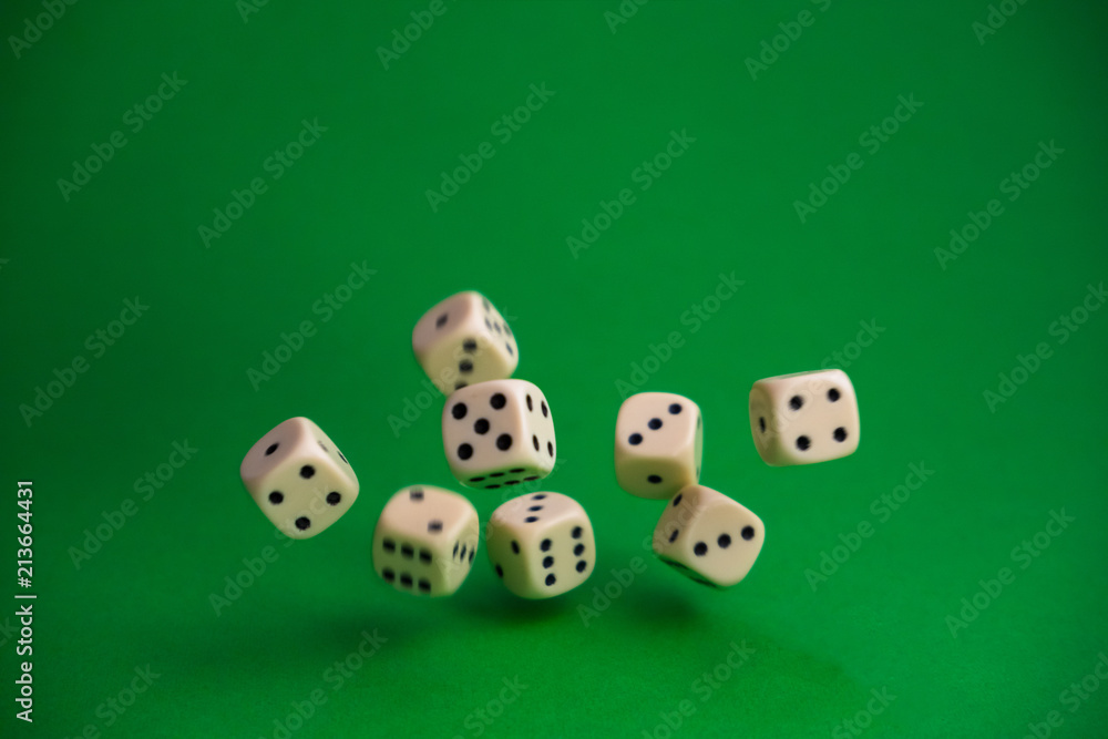 dice in the fall on a green background dice in the fall on a green background