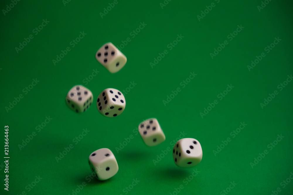 dice in the fall on a green background dice in the fall on a green background