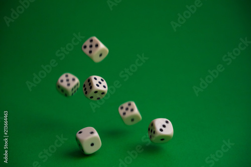dice in the fall on a green background