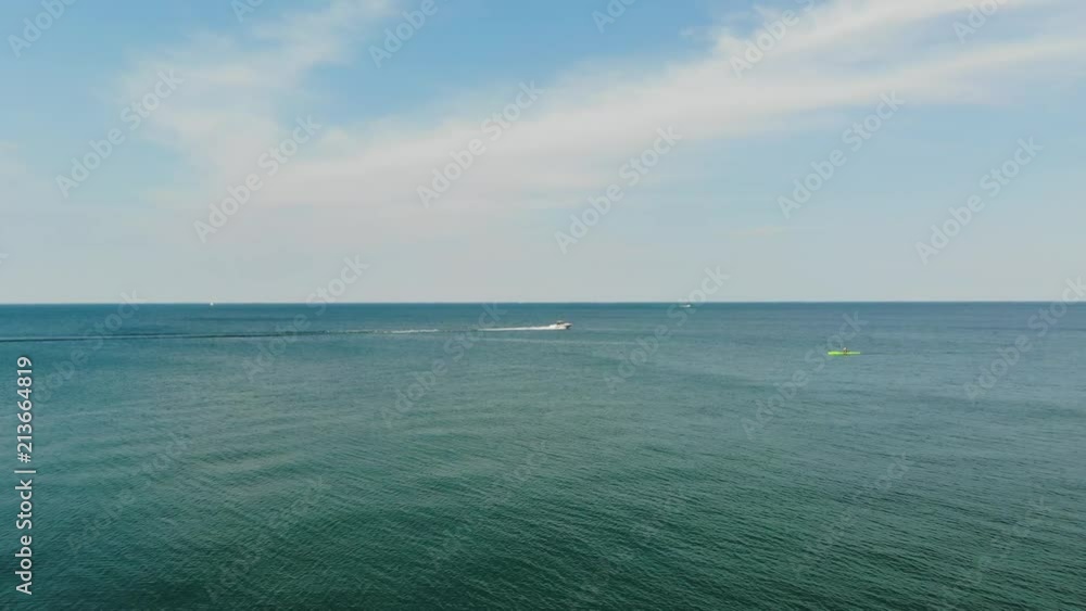 Boat and Kayaks in the distance in the ocean Boat and Kayaks in the distance in the ocean