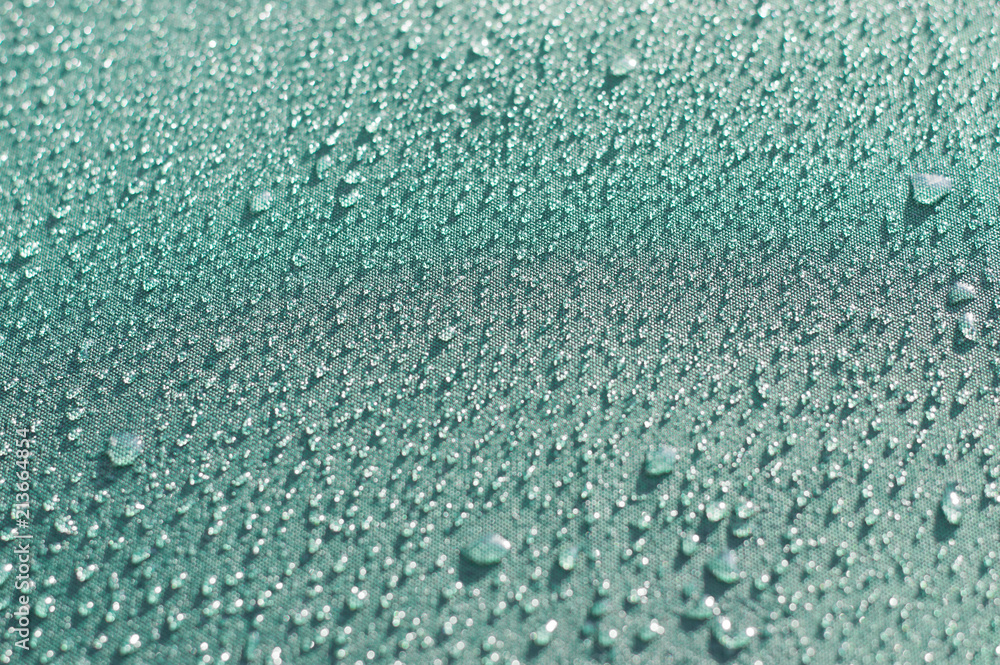 Obraz premium Small drops on a blue surface