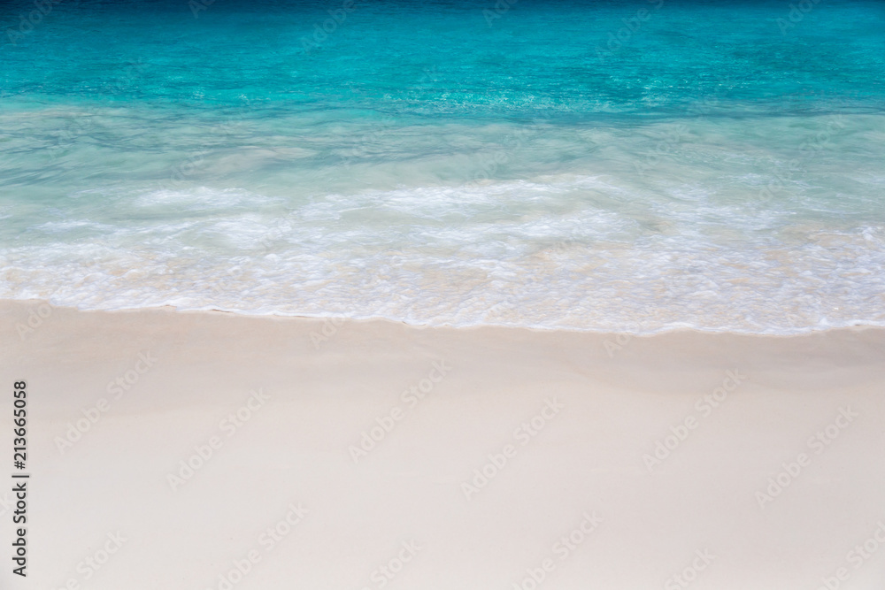 The beach with white sand and turquoise water with waves