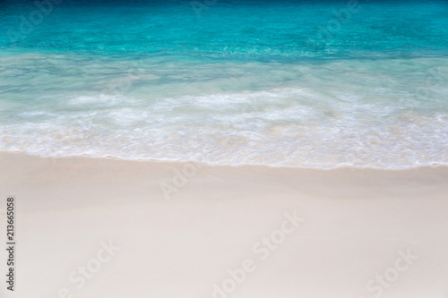 The beach with white sand and turquoise water with waves