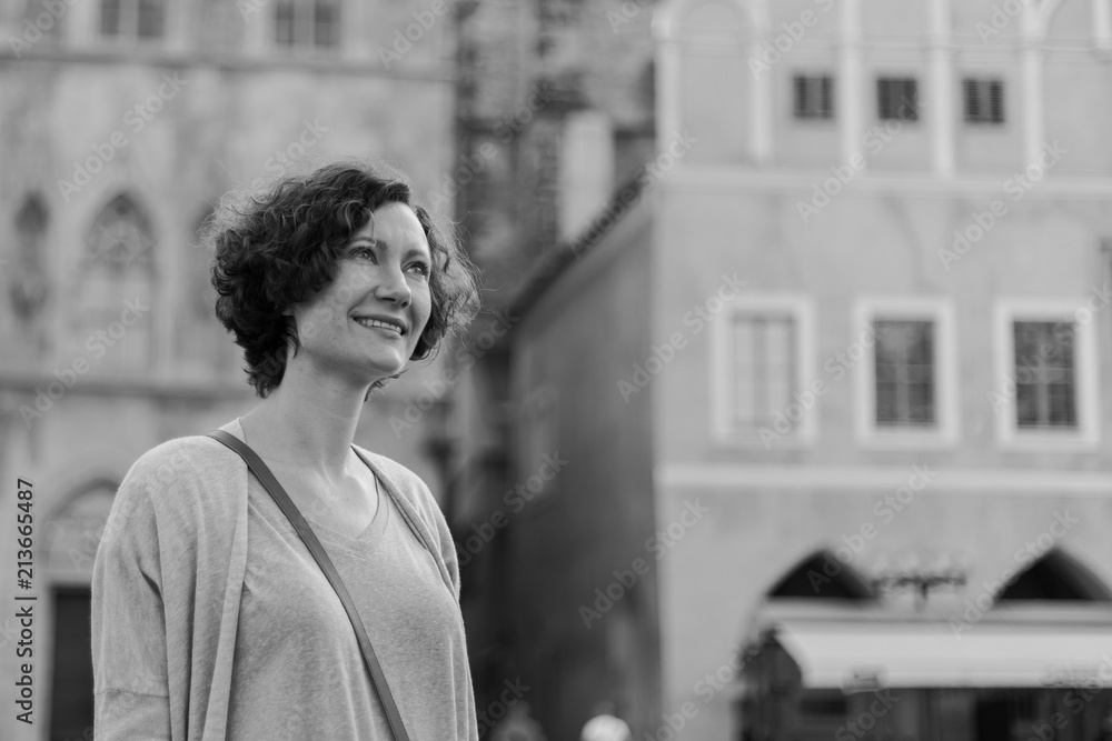 a woman is walking around the city in the spring day. Europe. Prague a woman is walking around the city in the spring day. Europe. Prague