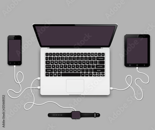 Mobile phone, tablet pc and smart watch connected to laptop computer