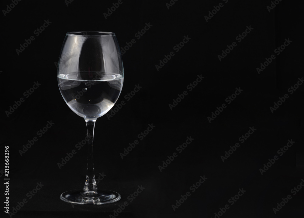 one transparent glass on a black background one transparent glass on a black background