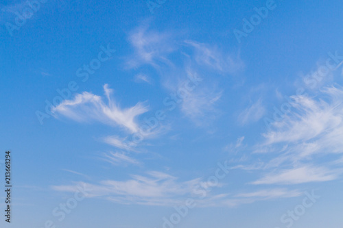 White feathery clouds on the blue sky in summer