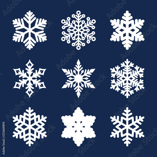 Vector set of 9 white snowflakes isolated on dark background. New year and Christmas design elements. Christmas snowflakes icon set