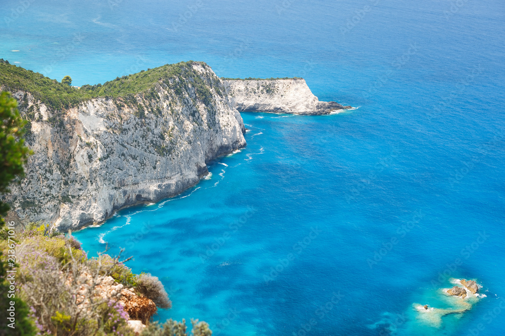 Magnificent coastline of Lefkada island. Aerial view of turquoise blue sea from a cliff on a beautiful sunny day