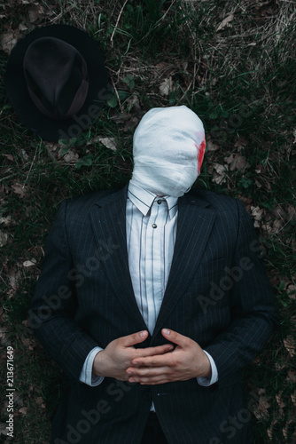 Photography Serial maniac lies on the ground in forest