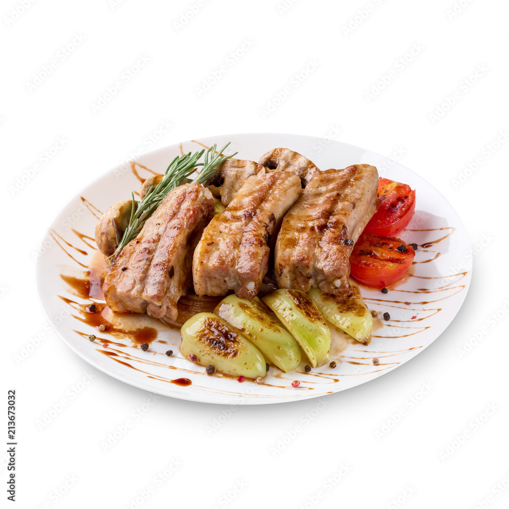 Tasty grilled ribs with vegetables on plate, isolated on white background