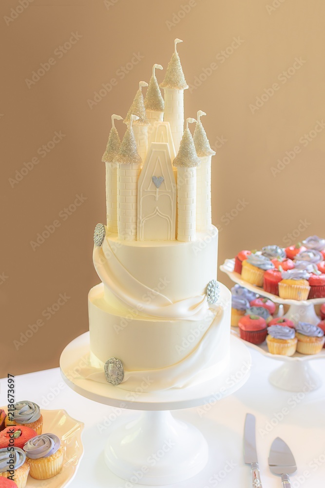 3 tier princess themed wedding cake with edible castle topper. Stock ...