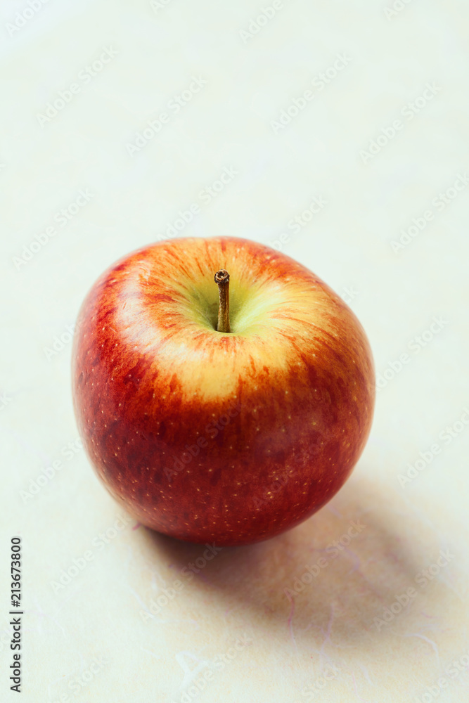 Single fresh apple on slightly colored background Single fresh apple on slightly colored background