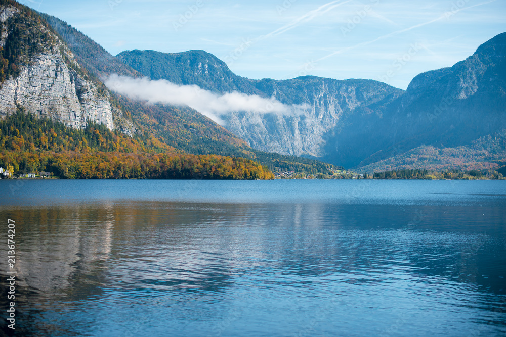 Wonderful scenic view of calm lake and Autumn mountains with the fog on the background. Hallstatt, Austria