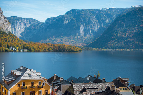 Beautiful autumn view of Hallstatt lake, mountains and village with houses and church in Austria. Beautiful countryside in autumn.