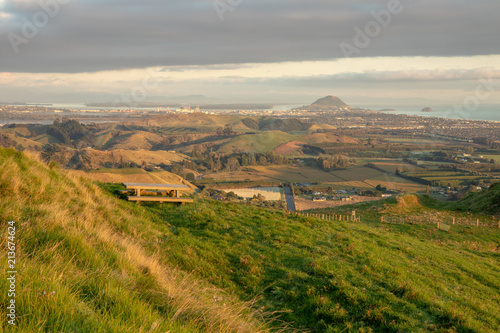 Peaceful landscape scene with bench and view on the ocean. Very quiet and peaceful morning. Amazing views, relaxing, pleasing on surrounding hills and countryside.