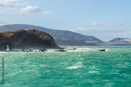 Amazing dramatic seascape. Rocky shore with waves, crystal clear water. Travel, sail, boat, ship, adventure, explore.