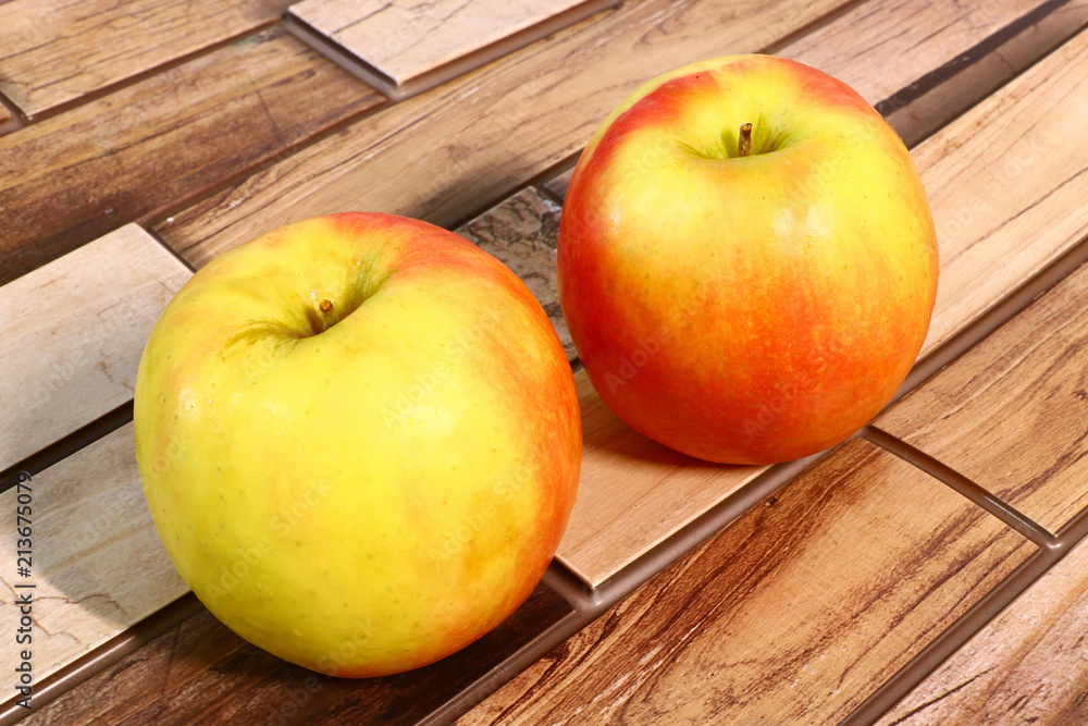 juicy and ripe apples on a wooden background juicy and ripe apples on a wooden background