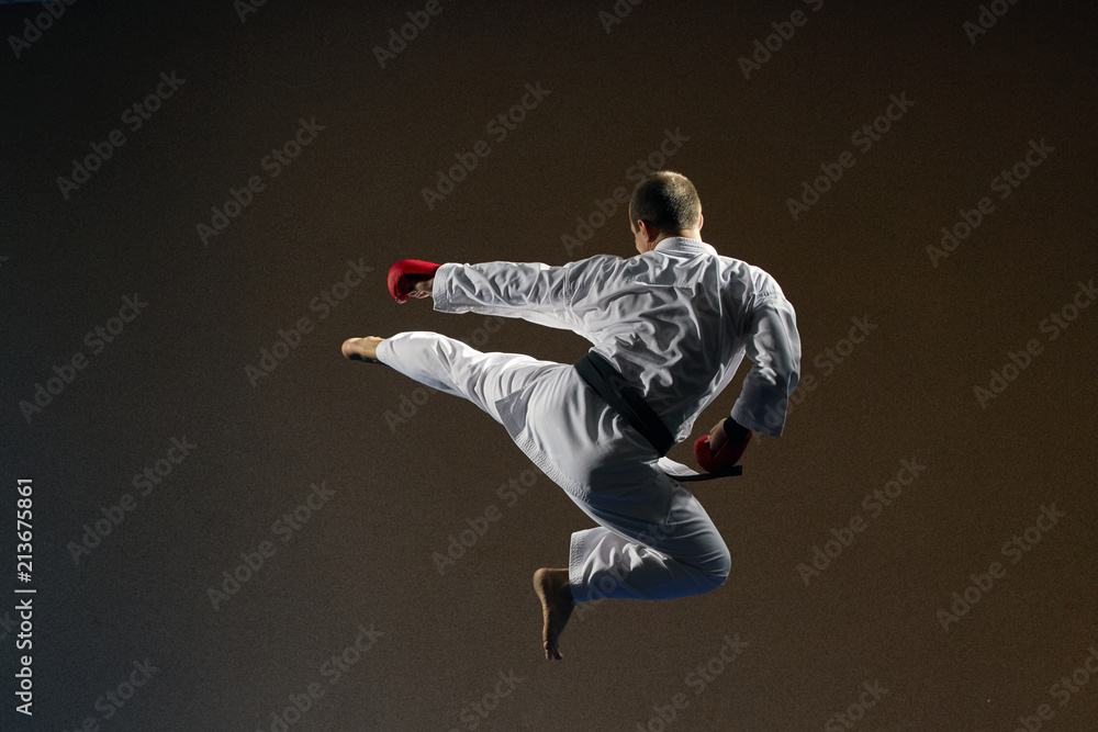 In karategi, an athlete beats a kick to the side in a jump