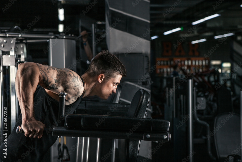 Athlete on uneven bars doing triceps exercises